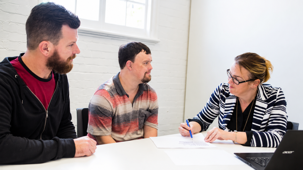 Supported Independent Living consultation between an NDIS participant, family member, and support professional